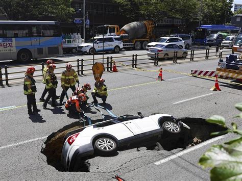 A sinkhole swallows an SUV in South Korea, injuring 2 people.